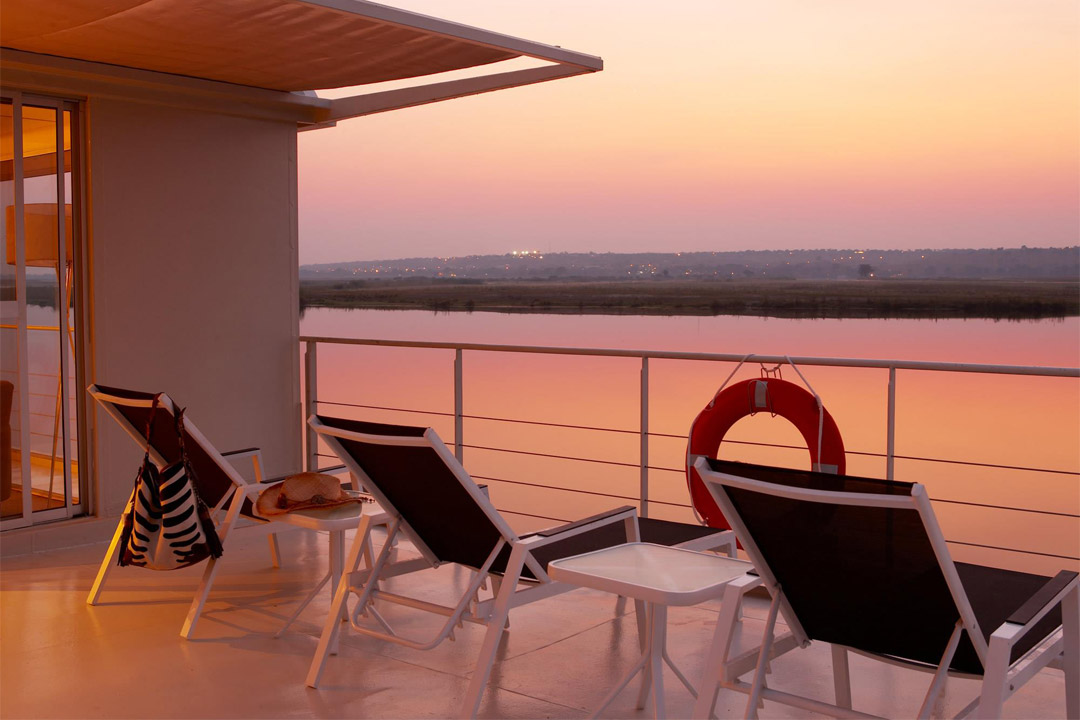 Enjoy unobstructed views of the river and African landscape while sailing on Zambezi Queen