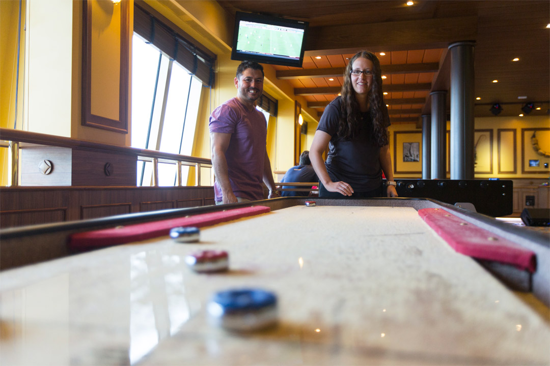  Enjoy a few rounds of shuffleboard at the onboard RedFrog Pub. 
