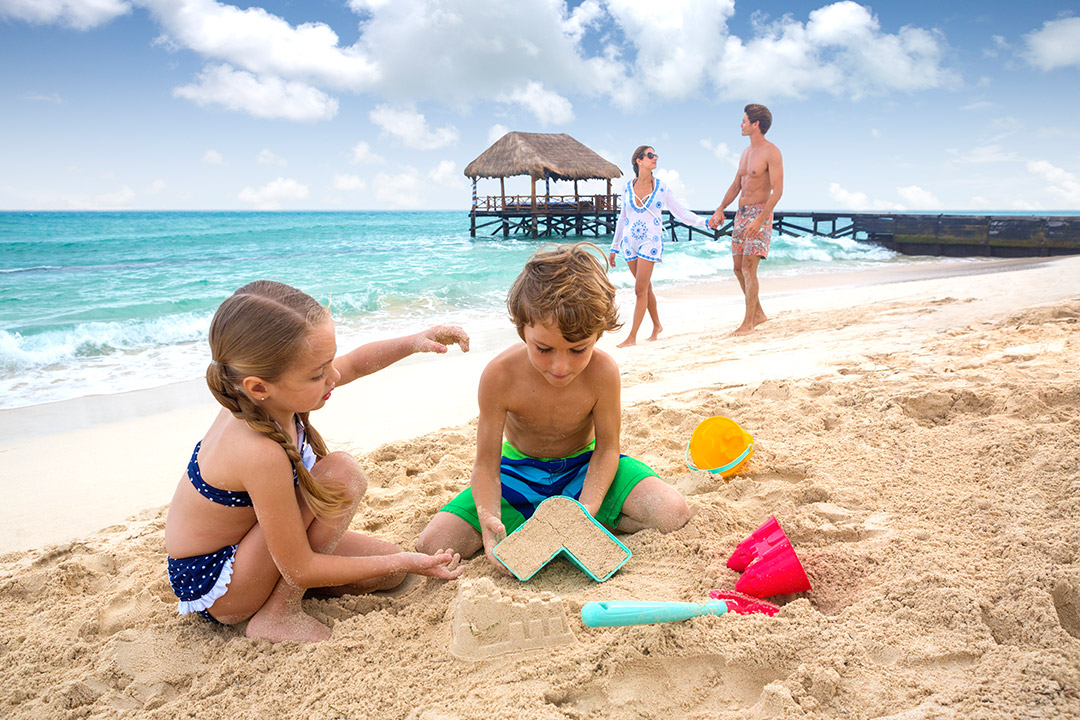 A family enjoying the beach at an Azul Resorts property.