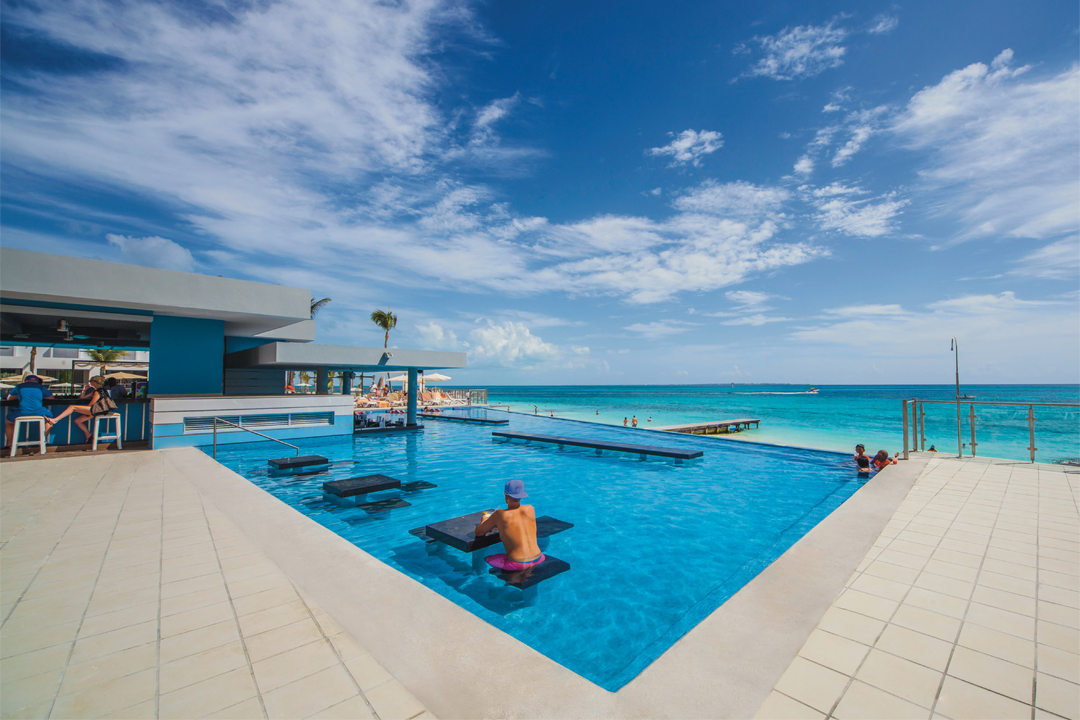 Grab a drink at the swim-up bar at Hotel Riu Cancun.
