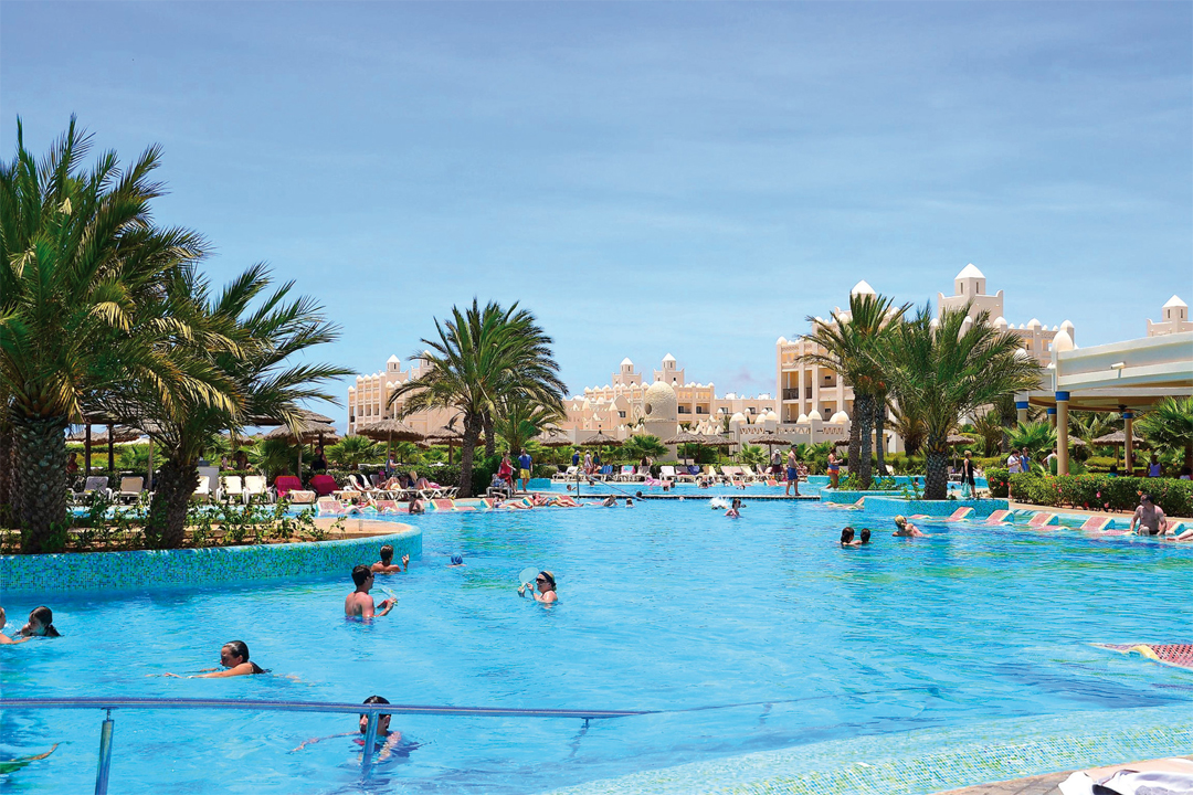 Enjoy a refreshing swim in the pool at Hotel Riu Karamboa.